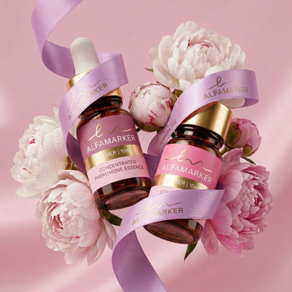 Two bottles of Alfamarker product surrounded by flowers on a pink background